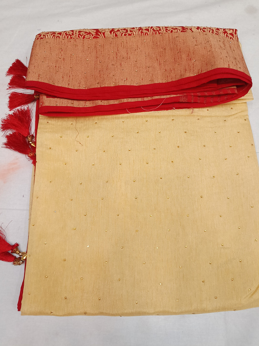 Off white cream and red color saree with stone work
