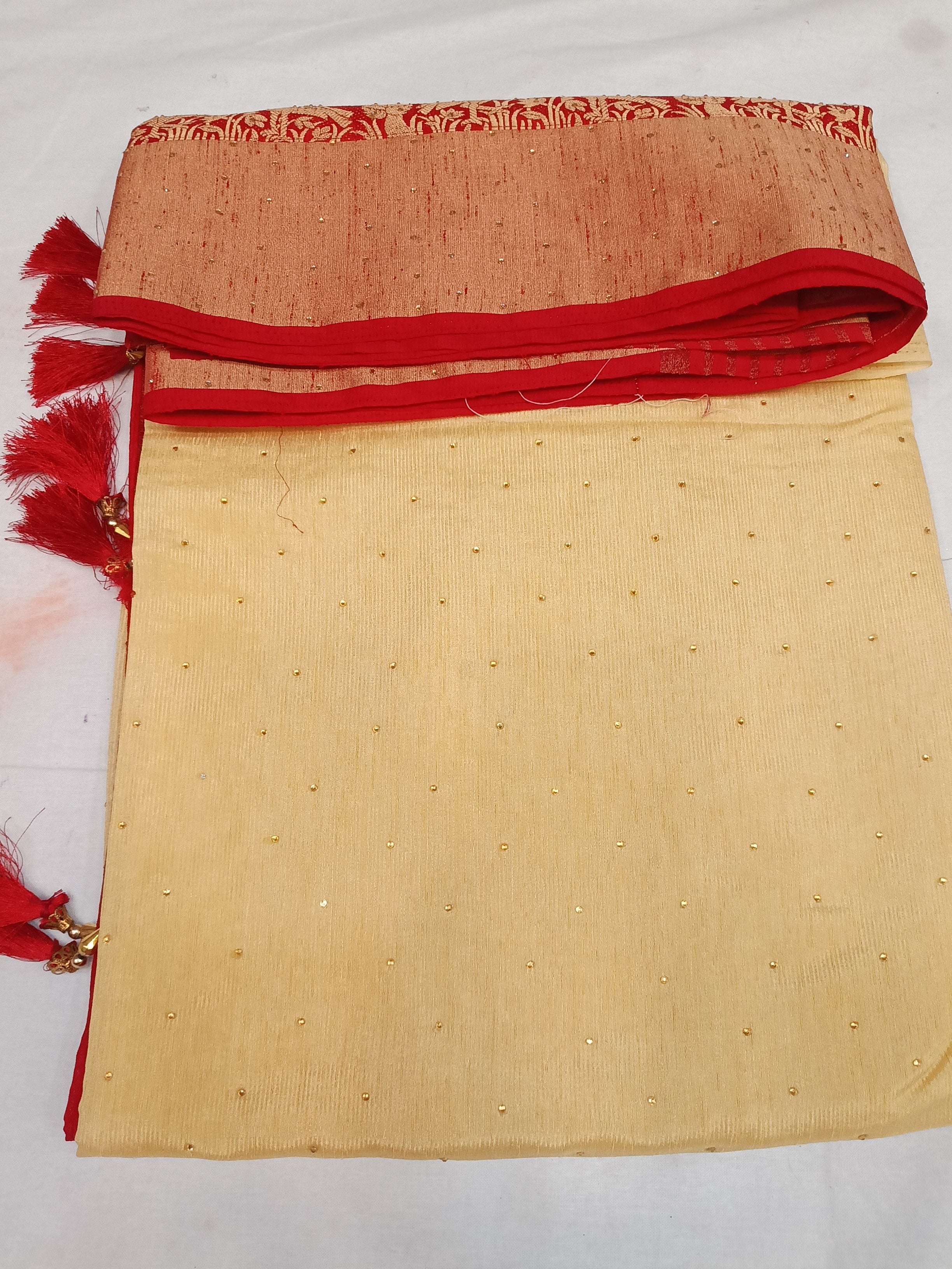 Off white cream and red color saree with stone work