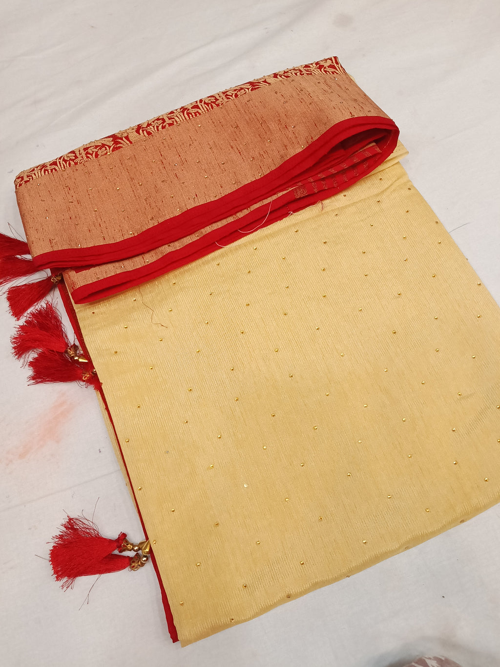 Off white cream and red color saree with stone work